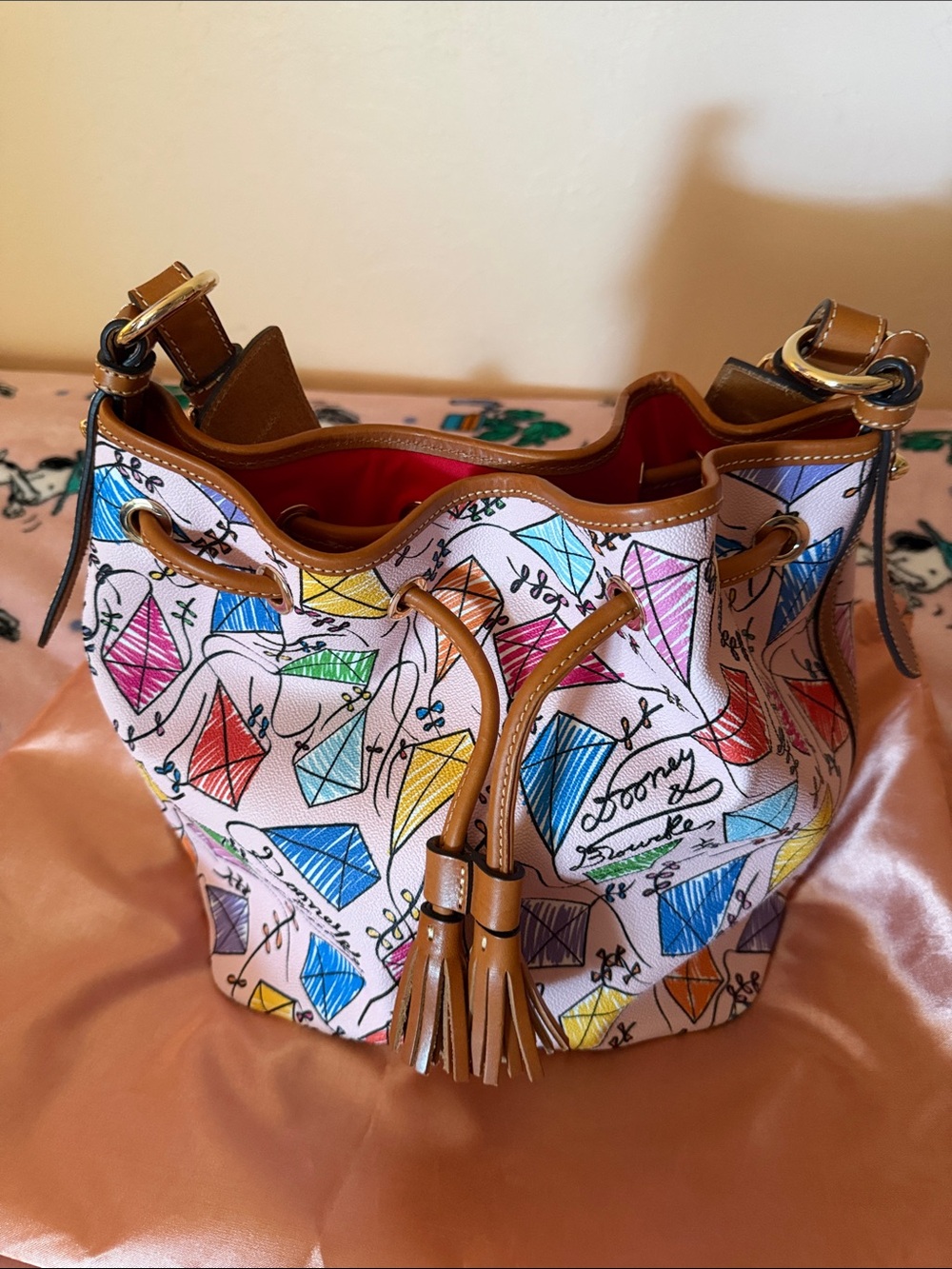 Dooney & Bourke Multicolor Kite-Print Drawstring Bucket Bag with Tan Trim
